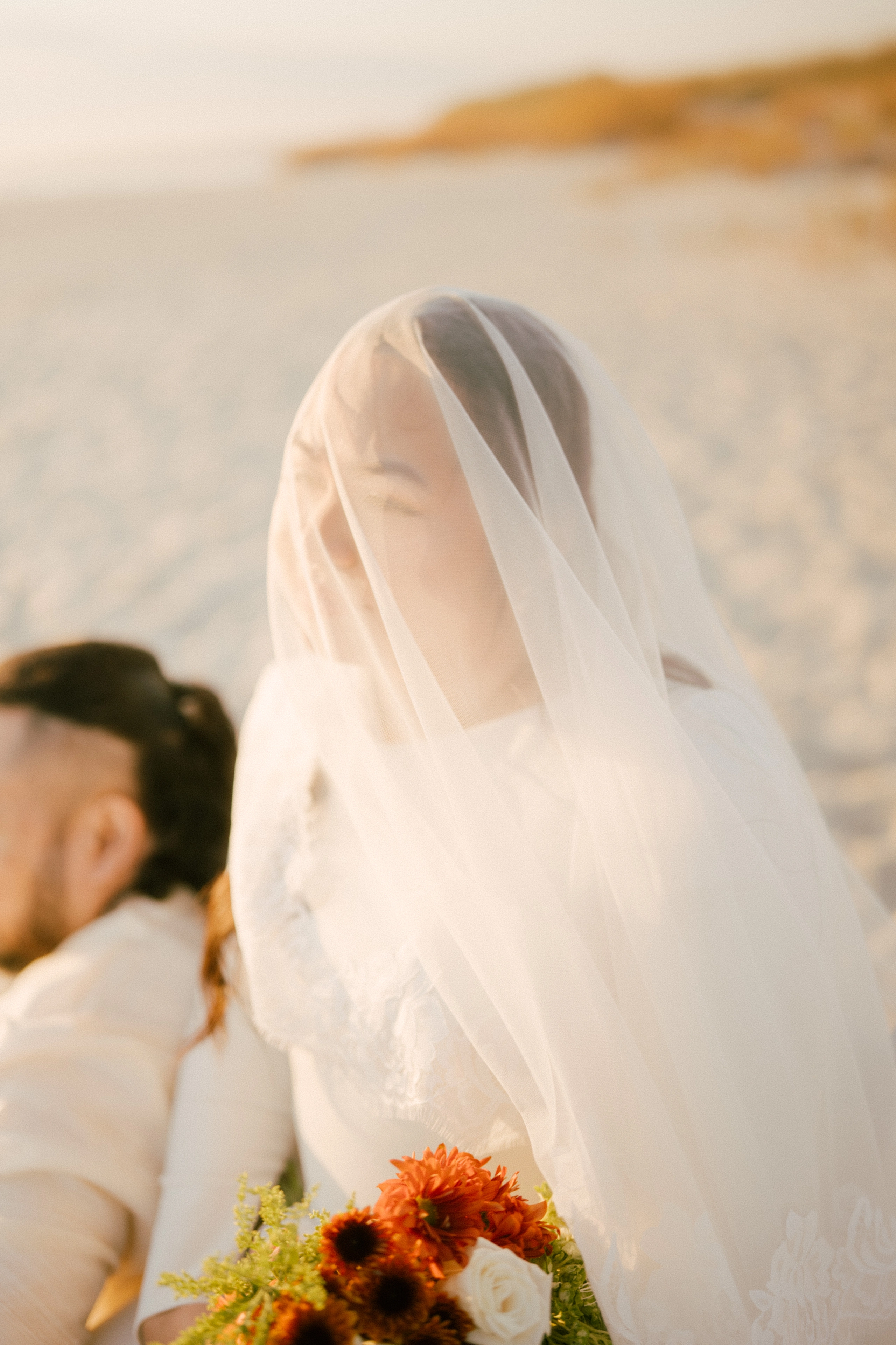 Multi-generational family sitting together on an outdoor porch.