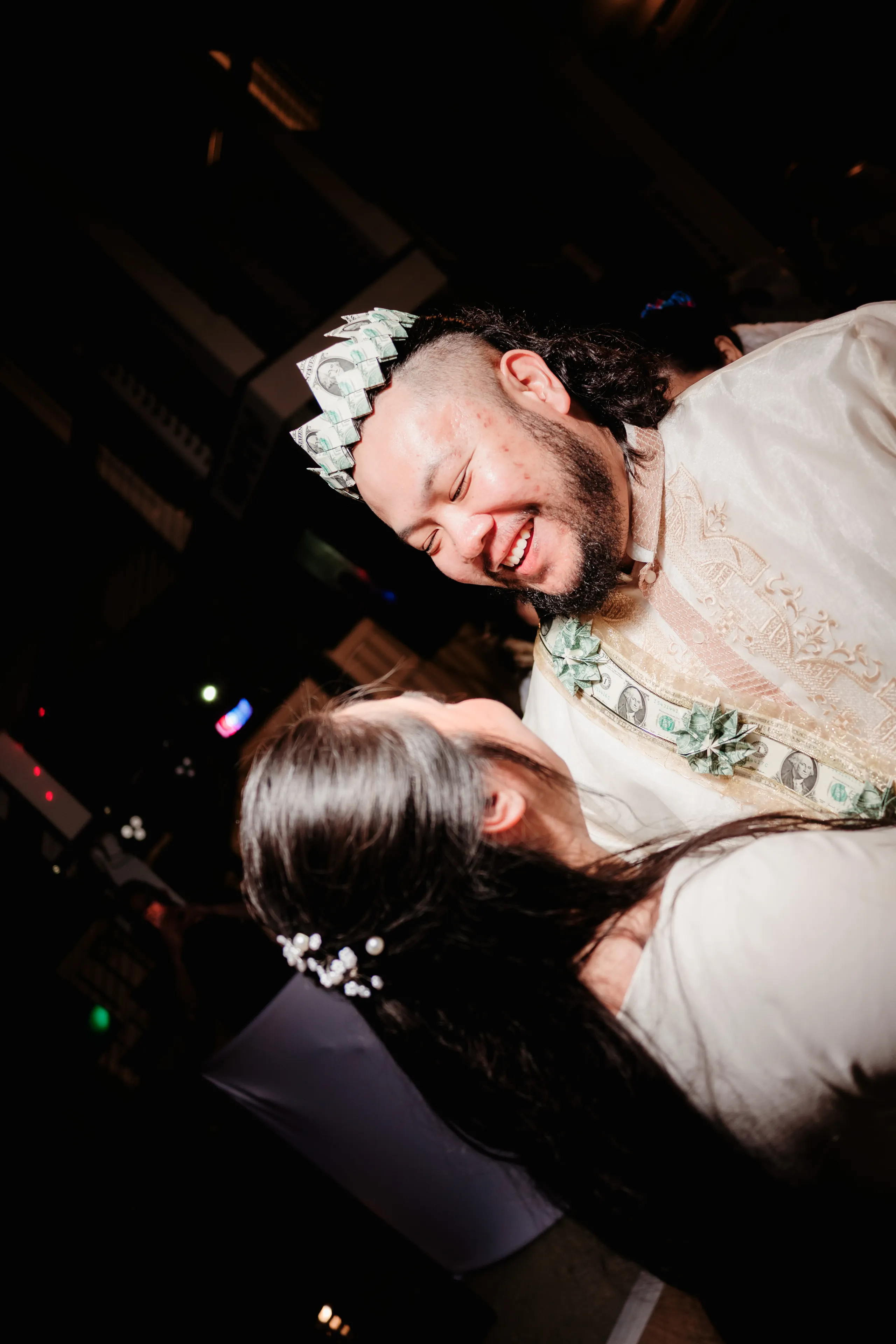 Black and white photo of friends sitting together outdoors.